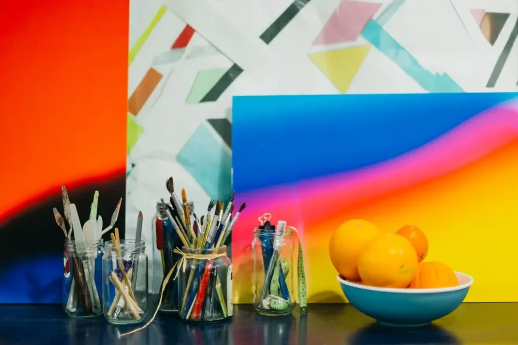 jars with drawing supplies near paintings fruits 23 2147802016